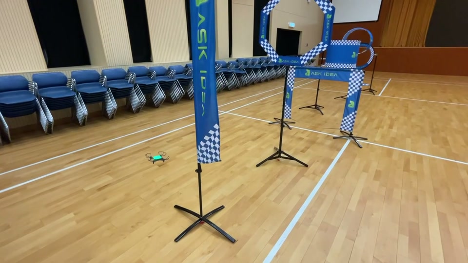 An indoor drone obstacle course with gates in a school activity hall